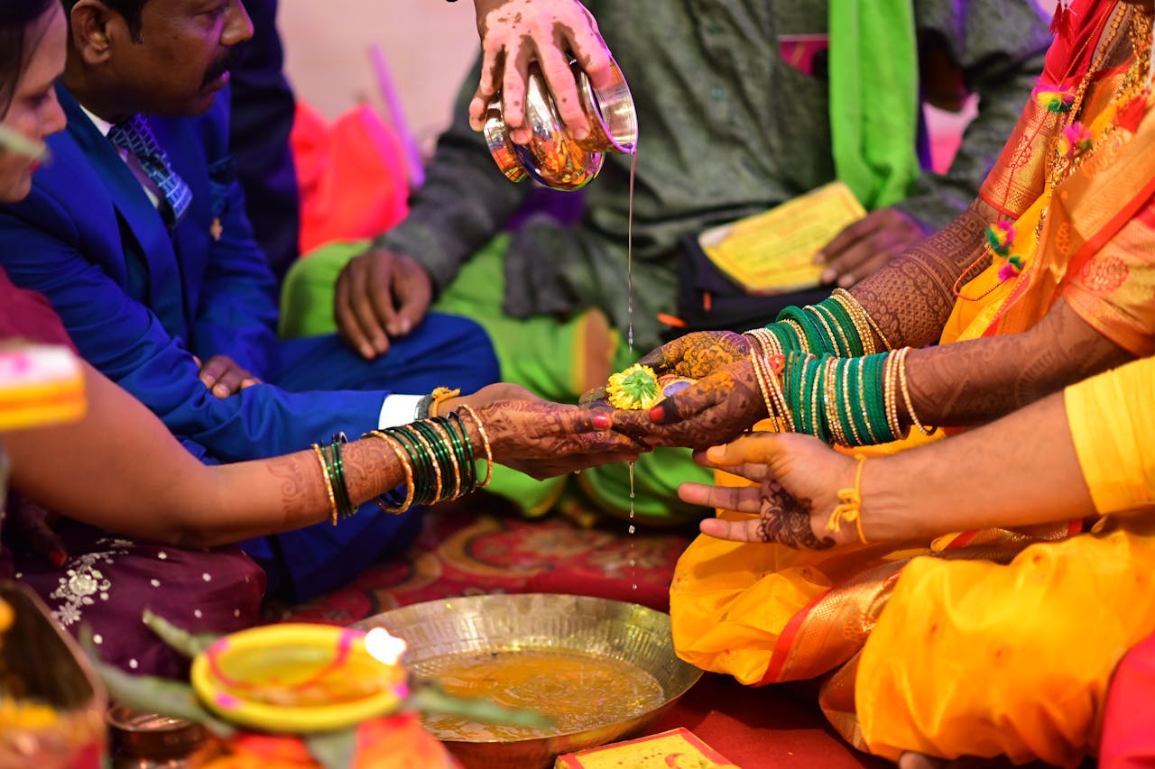 Close-up of a vibrant Indian wedding ceremony with hands and rituals.